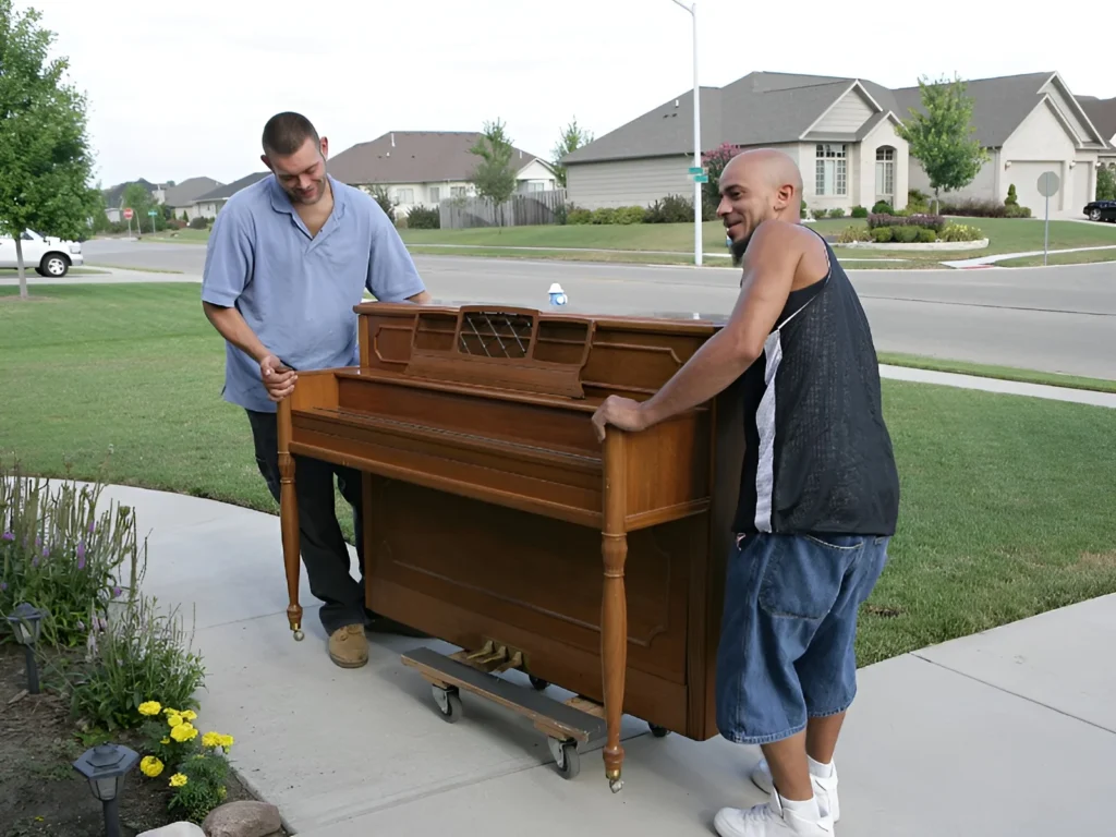 Image showing team moving heavy piano.