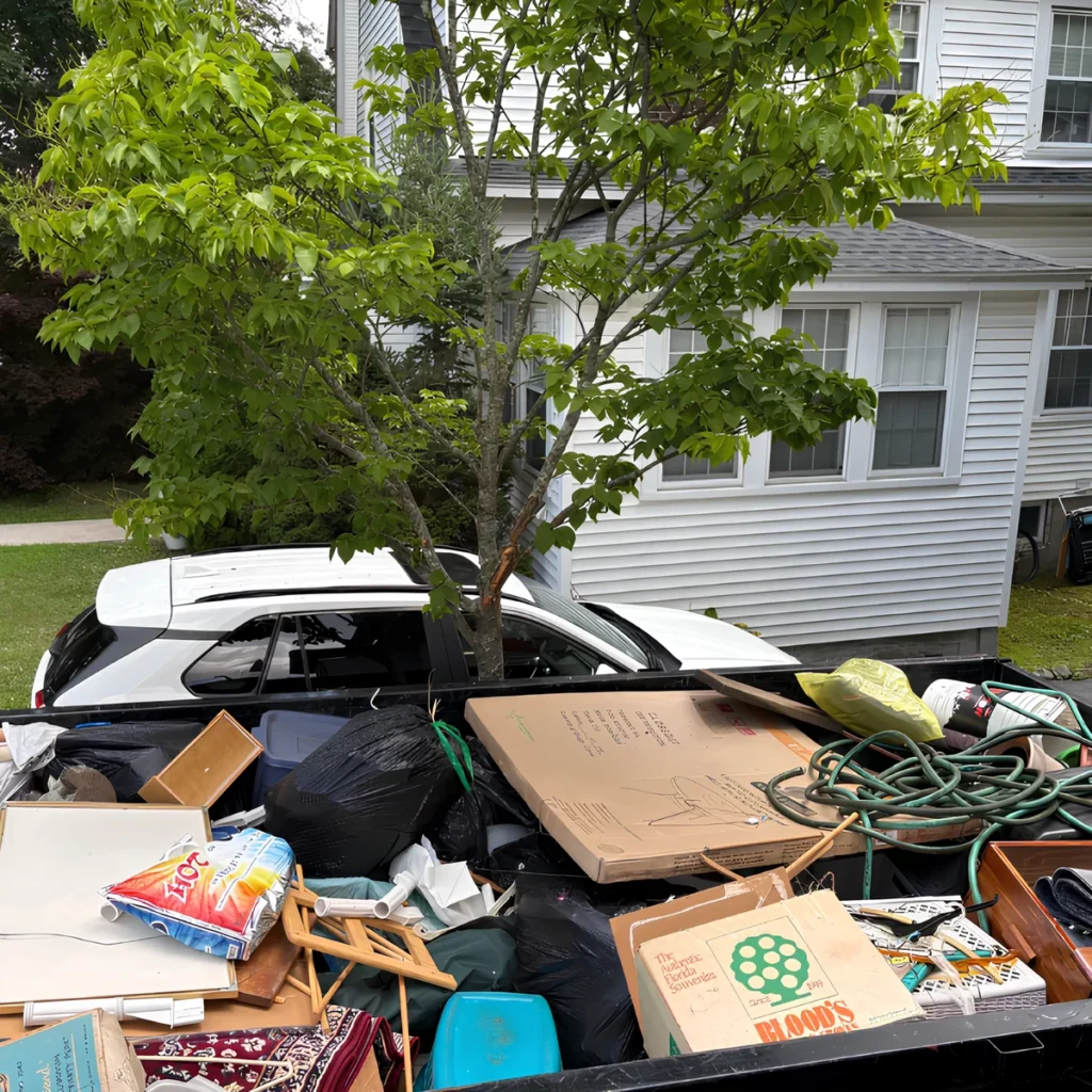 Image of household junk in a bin during a house cleanout.