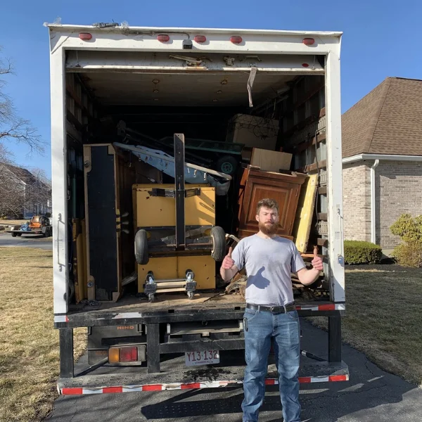 Image showing furniture and junk being loaded into a truck.